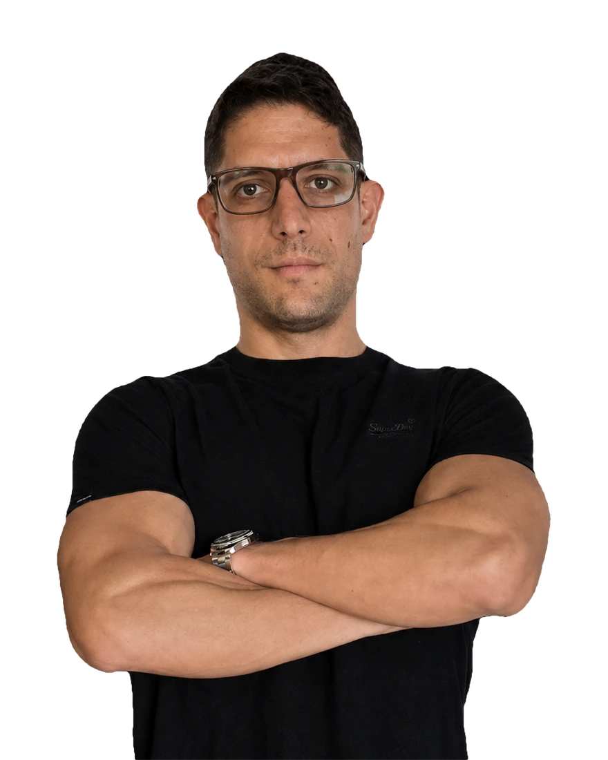 Juan Pablo Tagliaferro, arms folded, in a black t-shirt against a dark ground.